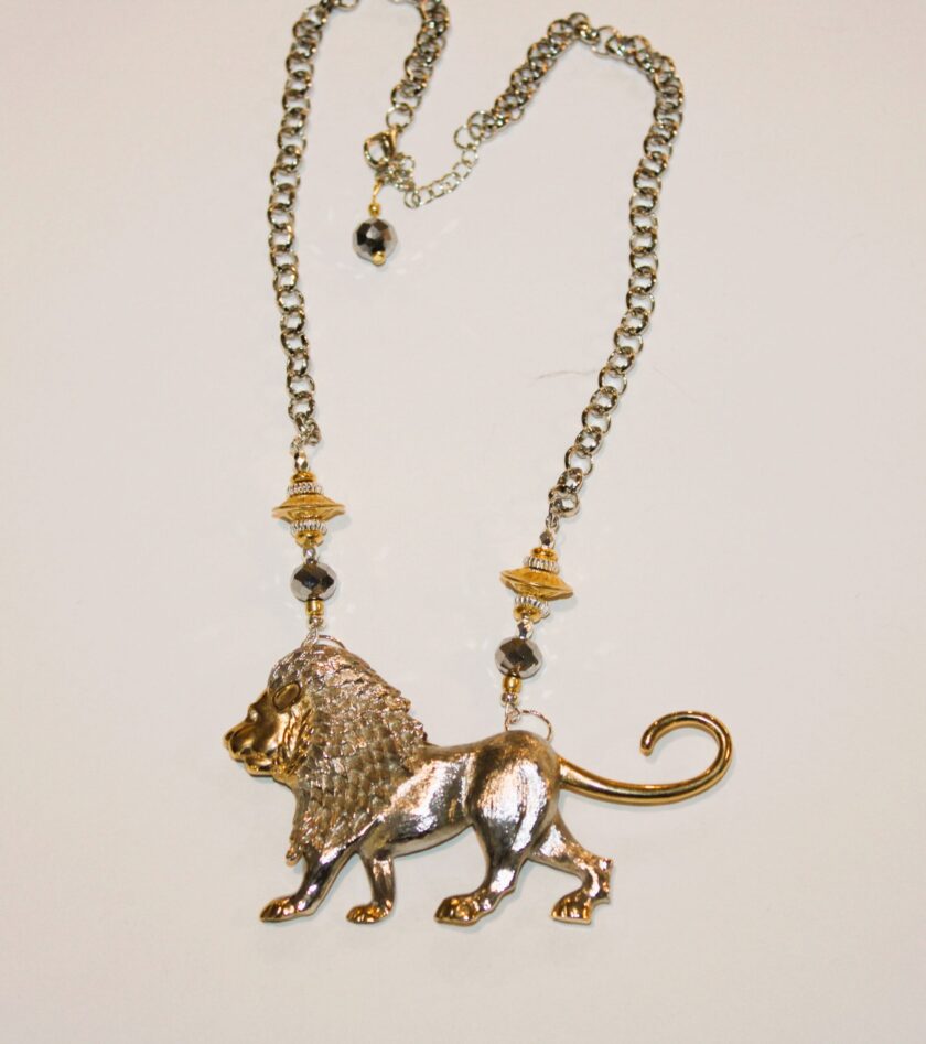 A necklace with a lion on it.