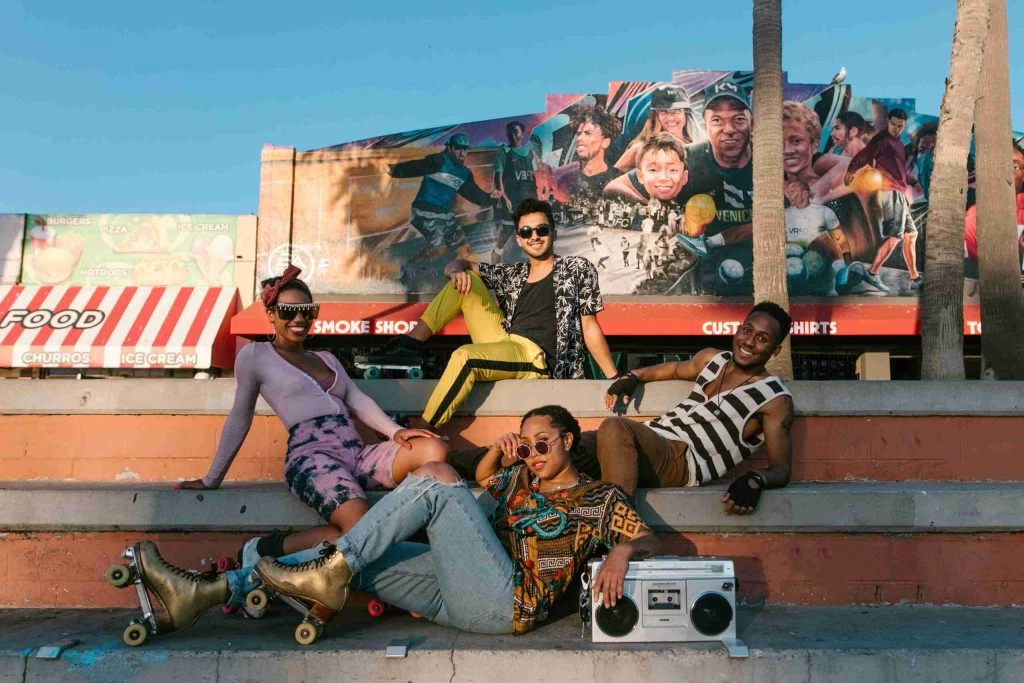 a group of people sitting on the steps of a building.