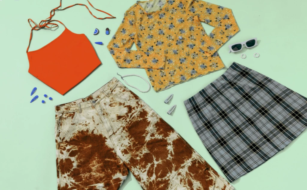 a variety of clothing and accessories laid out on a table.